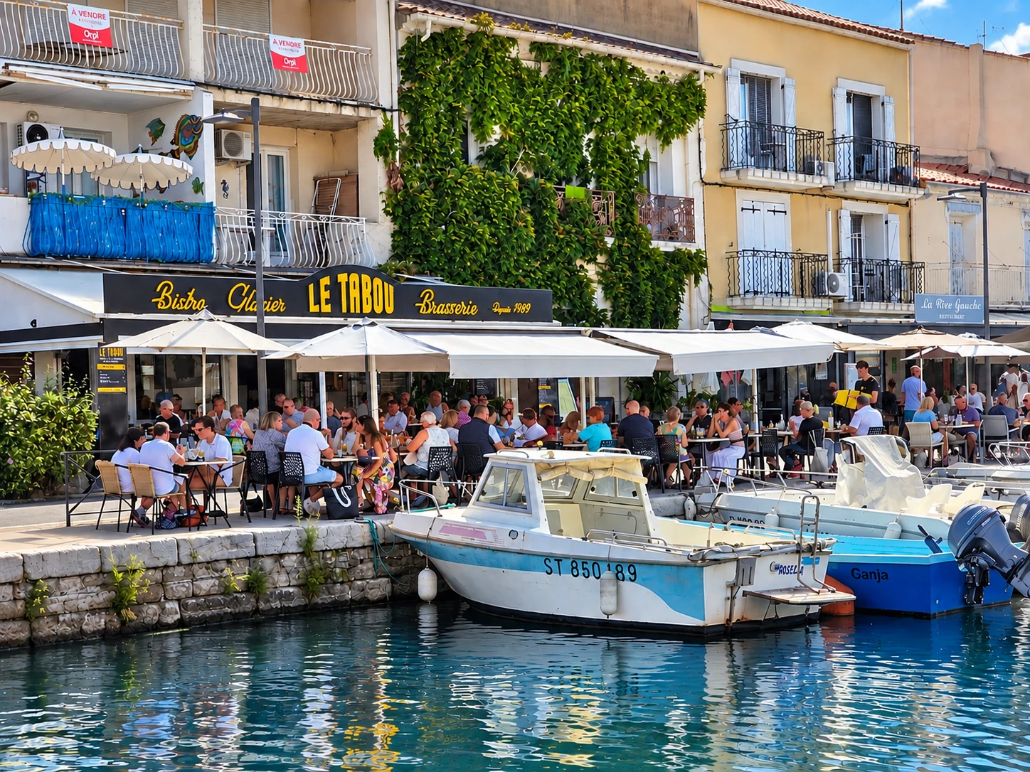 Terrace of Le Tabou restaurant at Mèze harbour